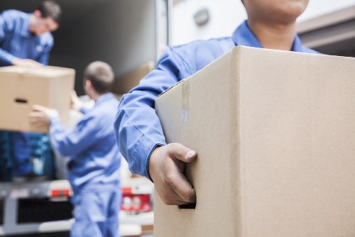A man loading boxes into a van for a London move